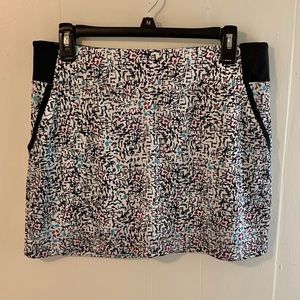 PGA Tour golf skort. Black with multi color print.  Size large.‎